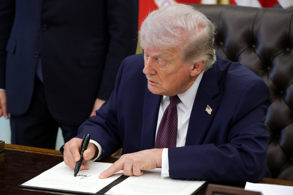 President Donald Trump signs an executive order in the Oval Office on March 31, 2026. (Alex Wong/Getty Images)