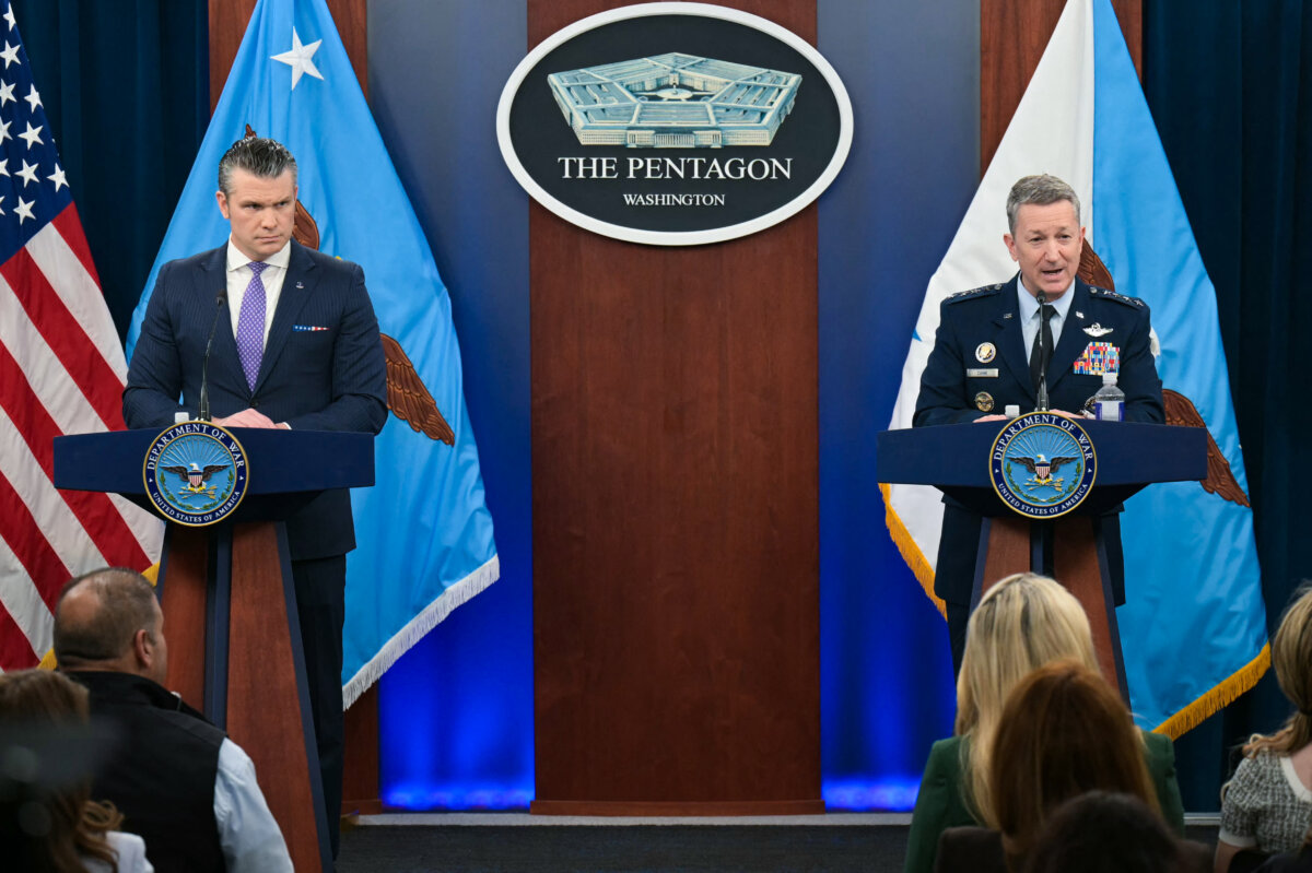 Secretary of War Pete Hegseth (L) looks on as Chairman of the Joint Chiefs of Staff Gen. Dan Caine speaks during a press briefing at the Pentagon in Arlington, Va., on March 31, 2026. (Oliver Contreras/AFP via Getty Images)