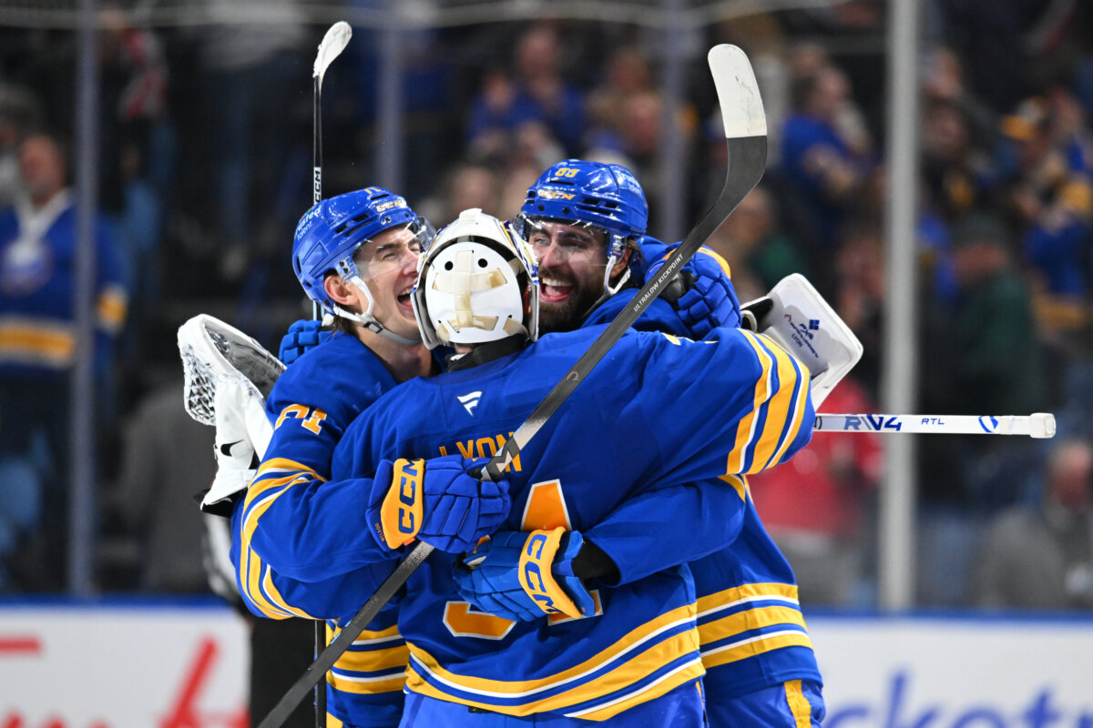 Alex Tuch (89) and Ryan McLeod (71) celebrate with teammate Alex Lyon (34) of the Buffalo Sabres after winning an NHL game against the Toronto Maple Leafs at KeyBank Center in Buffalo, New York, on March 14, 2026. (Joe Hrycych/Getty Images)