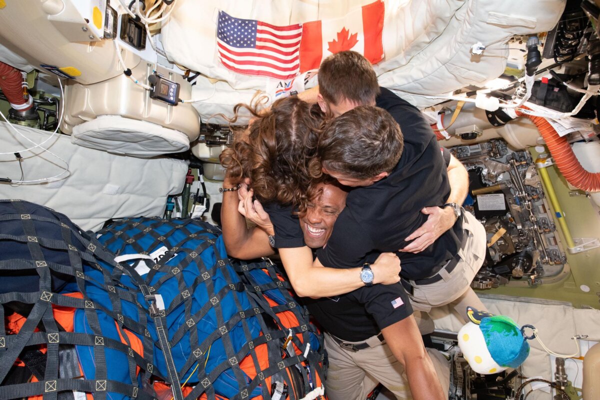 The Artemis II crew shares a group hug inside the Orion spacecraft on their way home on April 7, 2026. (NASA)