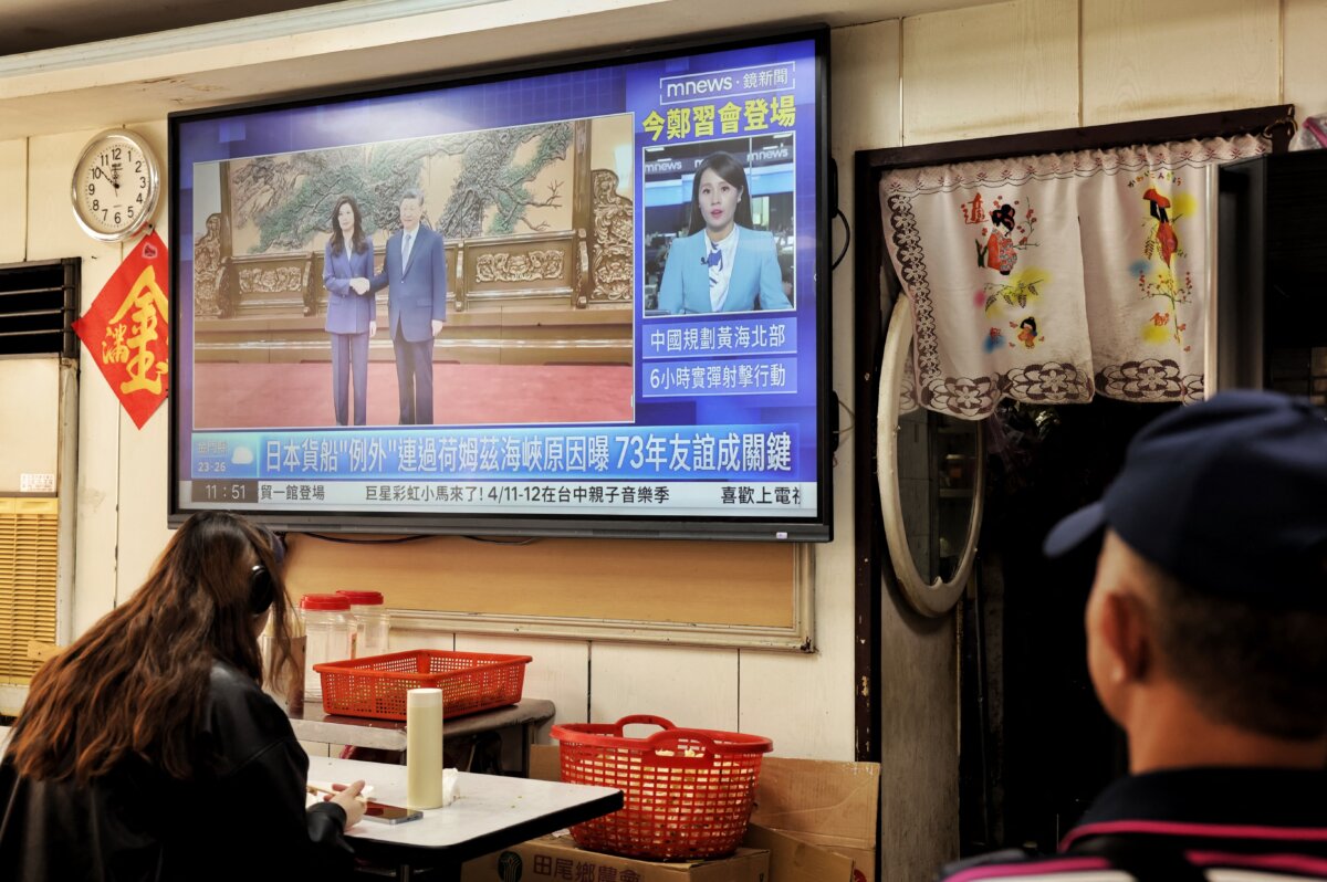 A television shows the meeting between Kuomintang (KMT) chairwoman Cheng Li-wun and Chinese leader Xi Jinping in Beijing, at a restaurant in Taipei, Taiwan, on April 10, 2026. (I-Hwa Cheng / AFP via Getty Images)