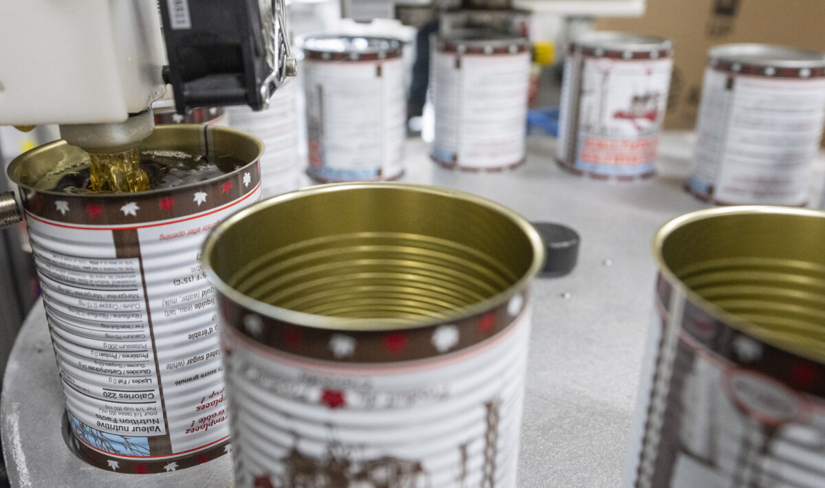 Maple syrup is canned at Erabliere Cote et Fils in Roxton Pond, Que., on March 9, 2026. (The Canadian Press/Christinne Muschi)
