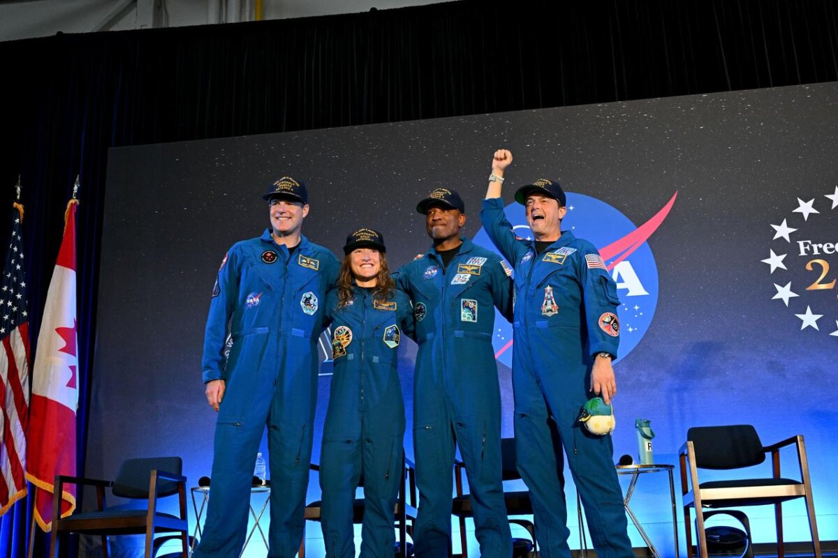 NASA’s Artemis II crew—(L–R) the Canadian Space Agency's Jeremy Hansen and NASA's Christina Koch, Victor Glover, and Commander Reid Wiseman—share brief remarks with friends, family, and colleagues at Ellington Field Joint Reserve Base in Houston after returning to Earth from a nearly 10-day journey around the moon, on April 11, 2026. (NASA/Helen Arase Vargas)