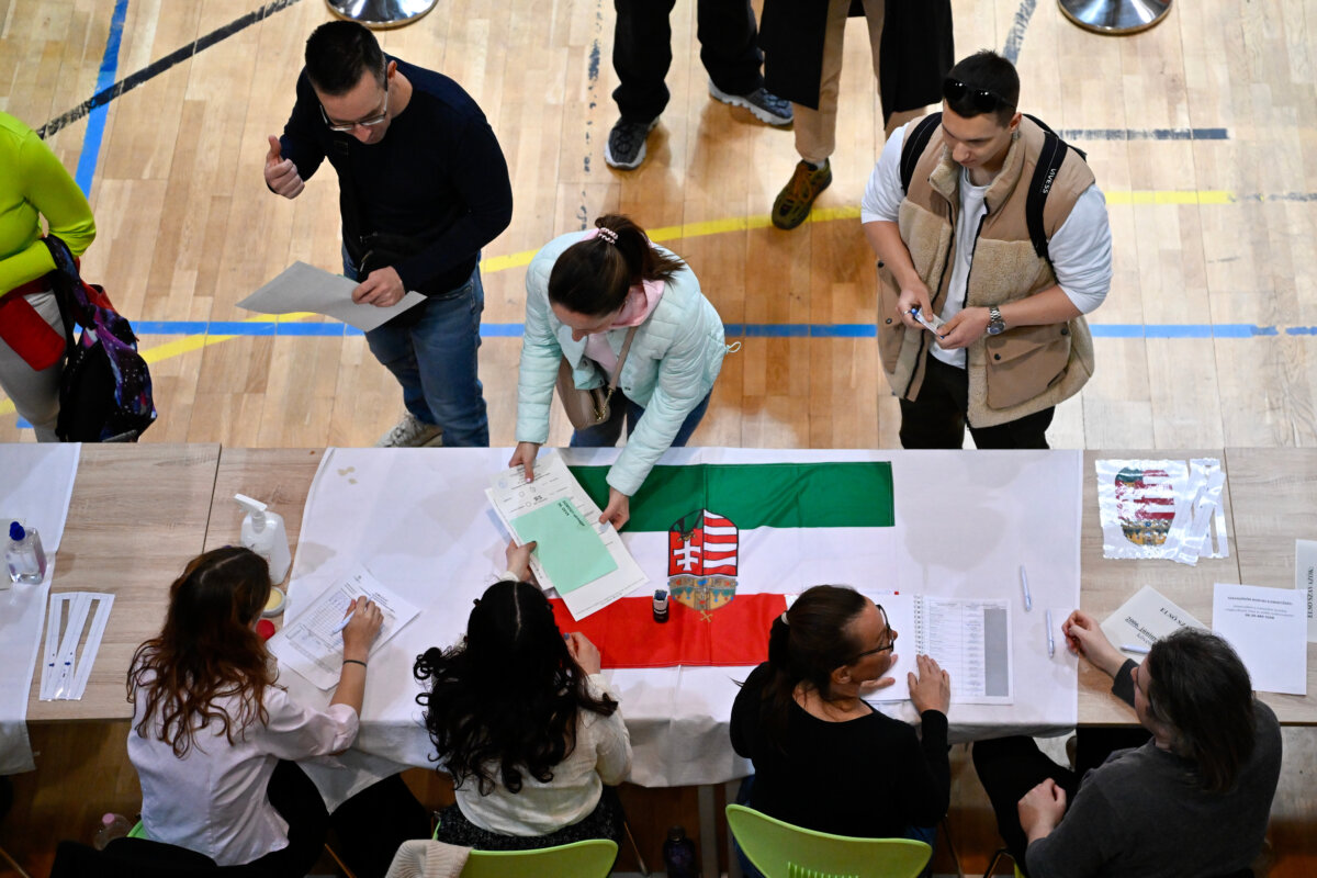 A woman takes ballots at a polling station during the Hungarian parliamentary election in Budapest on April 12, 2026. (Denes Erdos/AP Photo)