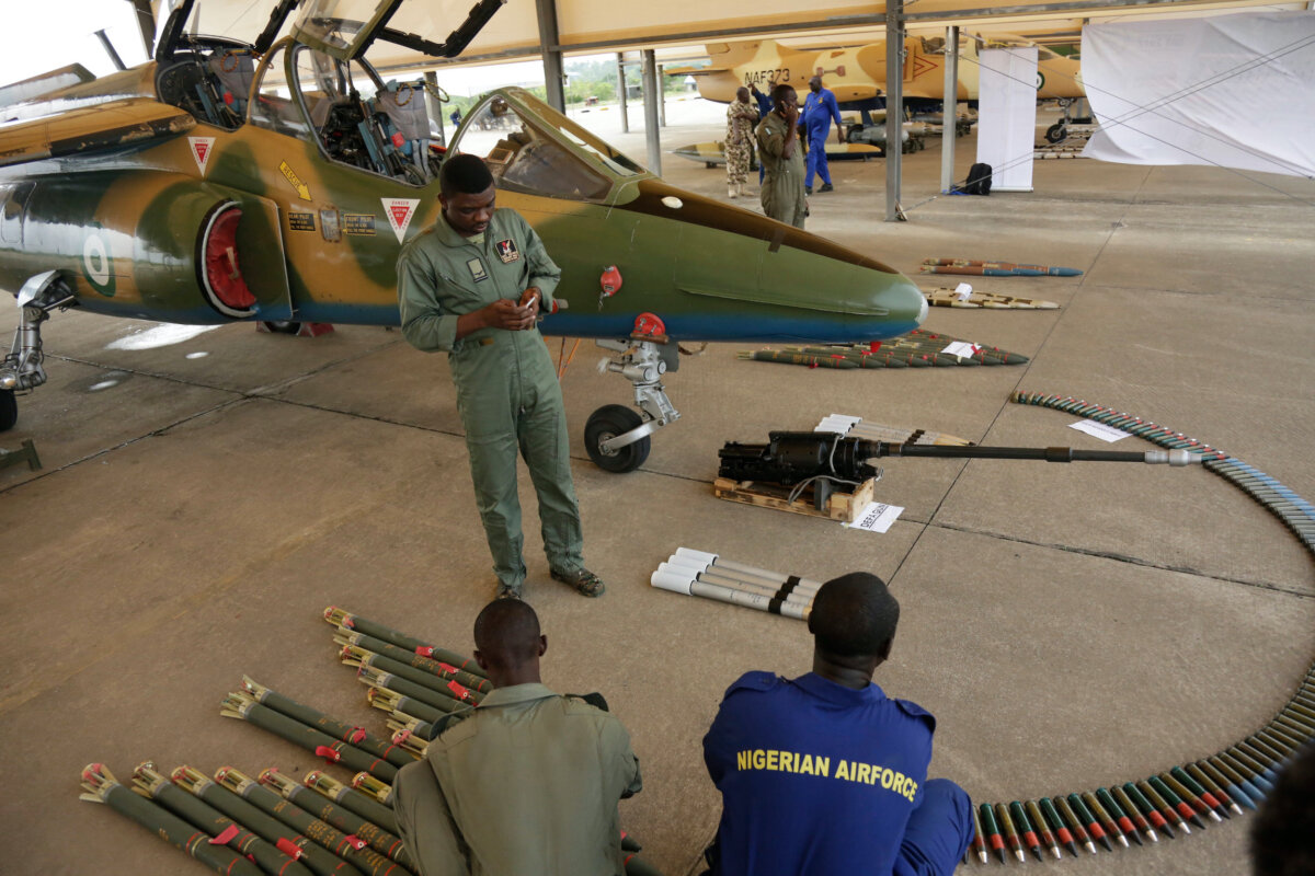 Nigerian Air Force officers display ammunition next to a fighter jet during an event in Makurdi, Nigeria, on April 22, 2017. (Sunday Alamba/AP Photo)