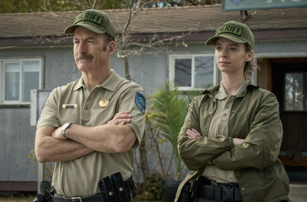 male and female law enforcement officers stand in front of building in Normal