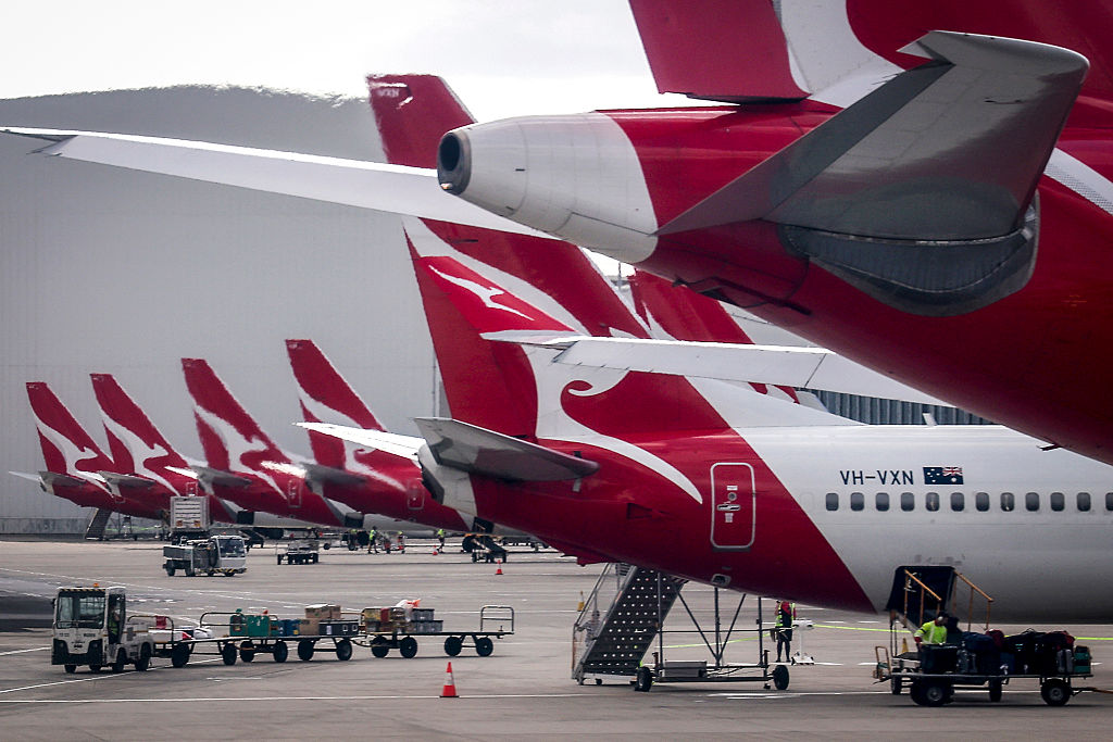 Qantas Airways ground staff are seen on the tarmac near planes at the domestic terminal of Sydney International Airport in Sydney, Australia on Jan. 14, 2026. (David Gray/ AFP via Getty Images)