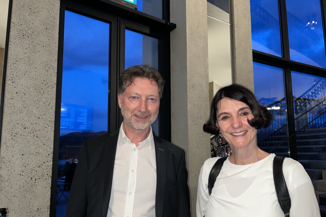 Herbert Johler, a senior employee at Austria’s Public Employment Service in Vorarlberg, attends Shen Yun in Füssen, Germany, on April 11, 2026, with Karin Grabher, a human resources professional in the glass industry. (An Ran/The Epoch Times)