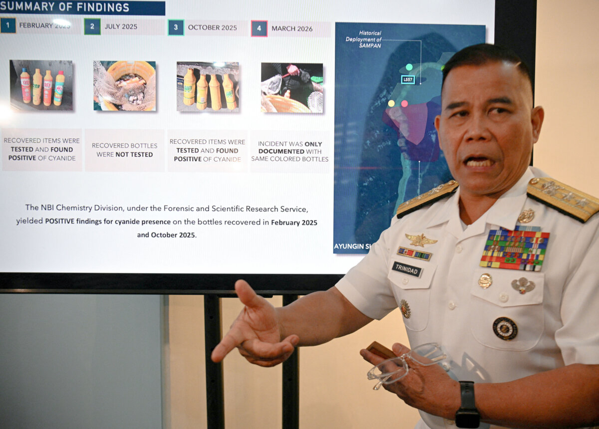 Philippine Navy spokesman Rear Admiral Roy Vincent Trinidad speaks next to a slide presentation of seized yellow bottles suspected to contain cyanide in waters of Second Thomas Shoal in the disputed South China Sea, during a press conference in Manila, Philippines, on April 13, 2026. (Ted ALJIBE/AFP via Getty Images)