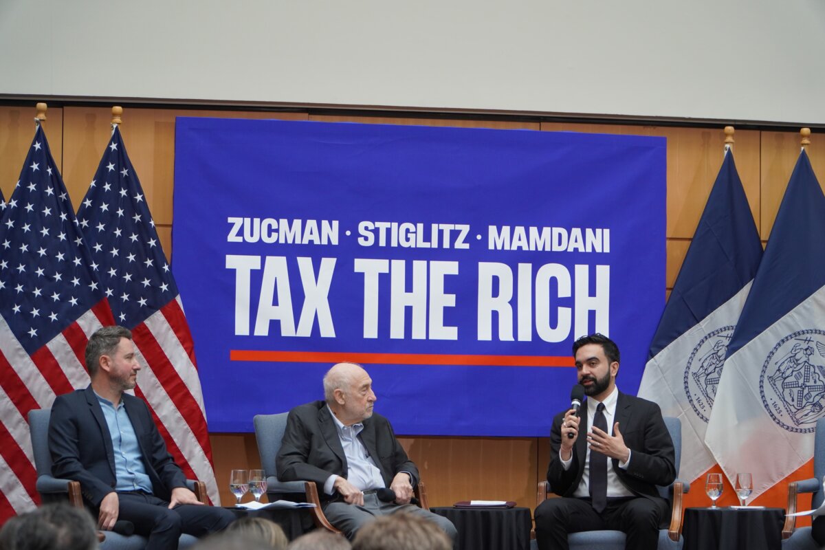 New York City Mayor Zohran Mamdani (R) with economists Gabriel Zucman (L) and Joseph Stiglitz at a Tax Day forum at the City University of New York Graduate Center on April 15, 2026. (Nicholas Zifcak/The Epoch Times)