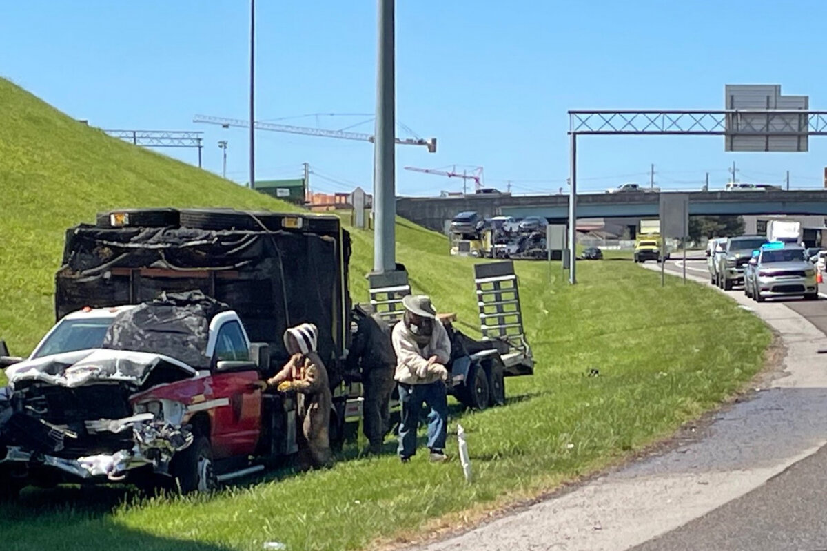 Beekeepers work to contain a swarm of bees that escaped from a crashed truck on Interstate 40 in Knoxville, Tenn., on April 17, 2026. (TDOT via AP)
