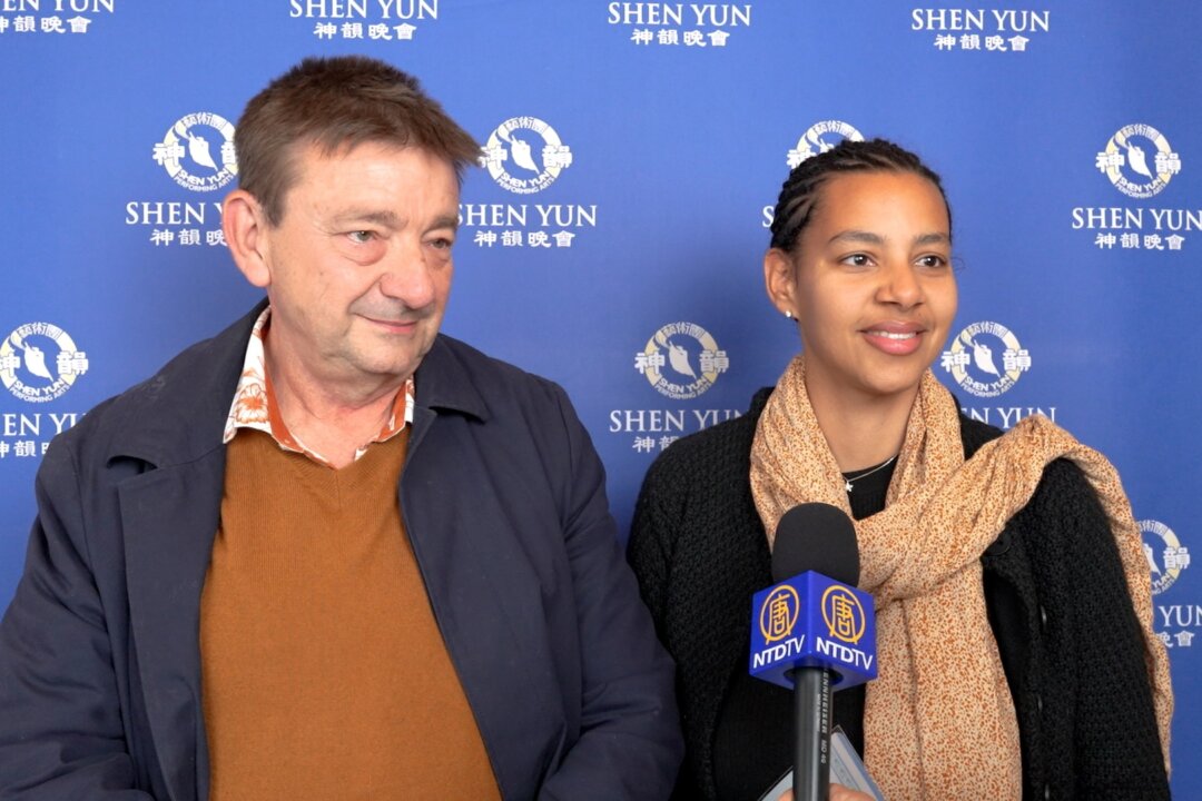 Daniel Eynard, a chocolatier, and his daughter, Laetitia Eynard, a nurse, watch Shen Yun Performing Arts in Aix, France, on April 15, 2026. (NTD)