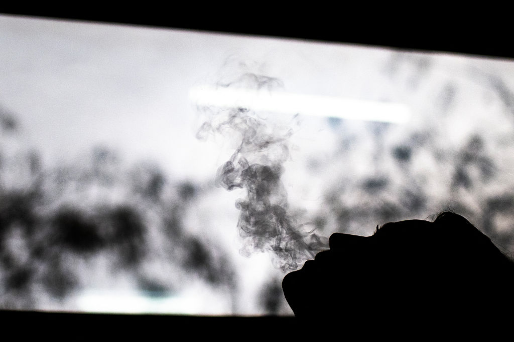A woman smokes an electronic cigarette in Paris on February 3, 2026. (Photo by Julie SEBADELHA / AFP via Getty Images)