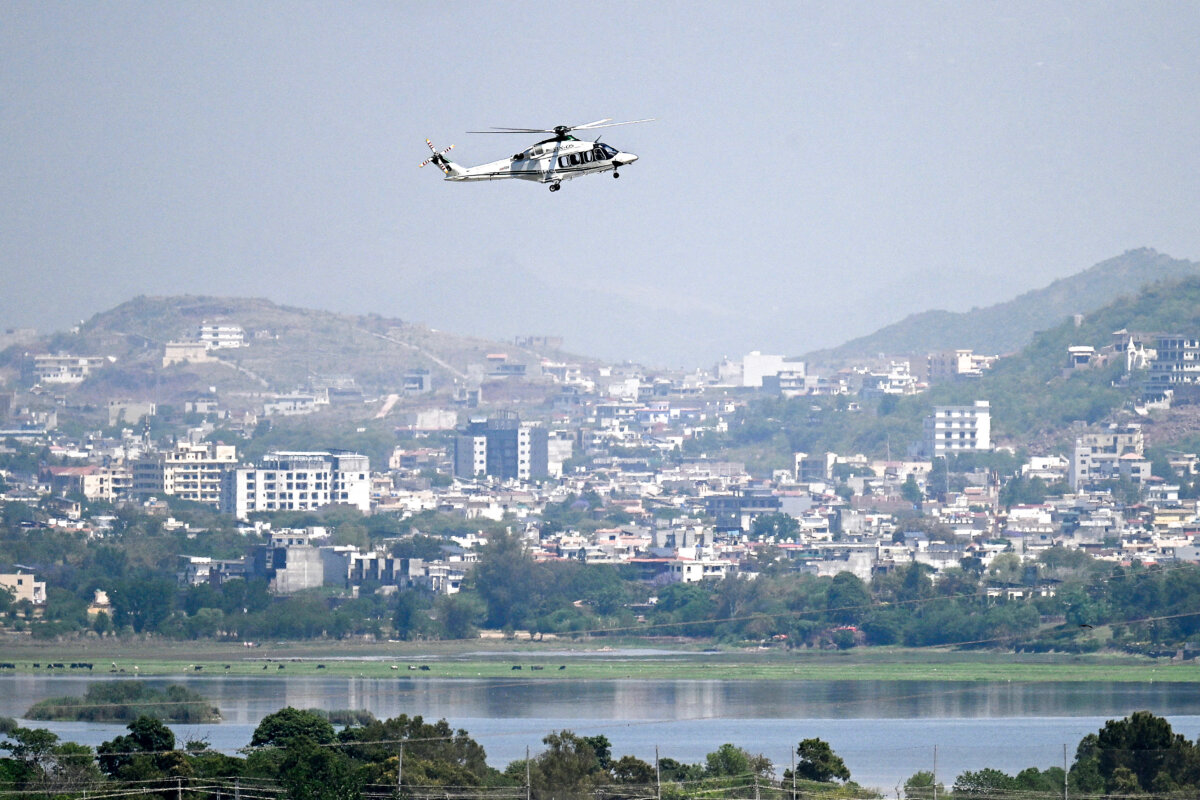 A helicopter flies over the Red Zone area amid heightened security measures ahead of anticipated U.S.–Iran peace talks, in Islamabad, Pakistan, on April 20, 2026. (Aamir Qureshi/AFP via Getty Images)