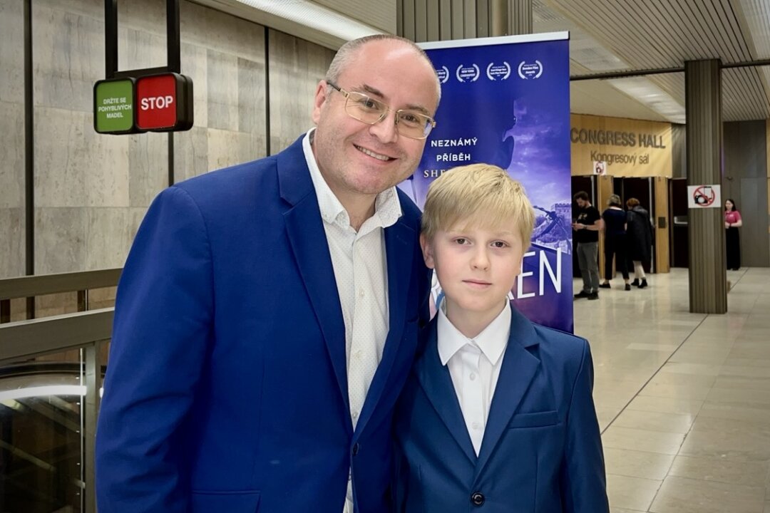 Martin J. Kadrman, vice president of the Czech Heritage Protection and Development Association, attends Shen Yun Performing Arts at the Prague Congress Center in the Czech Republic with his son on April 18, 2026. (An Ran/The Epoch Times)
