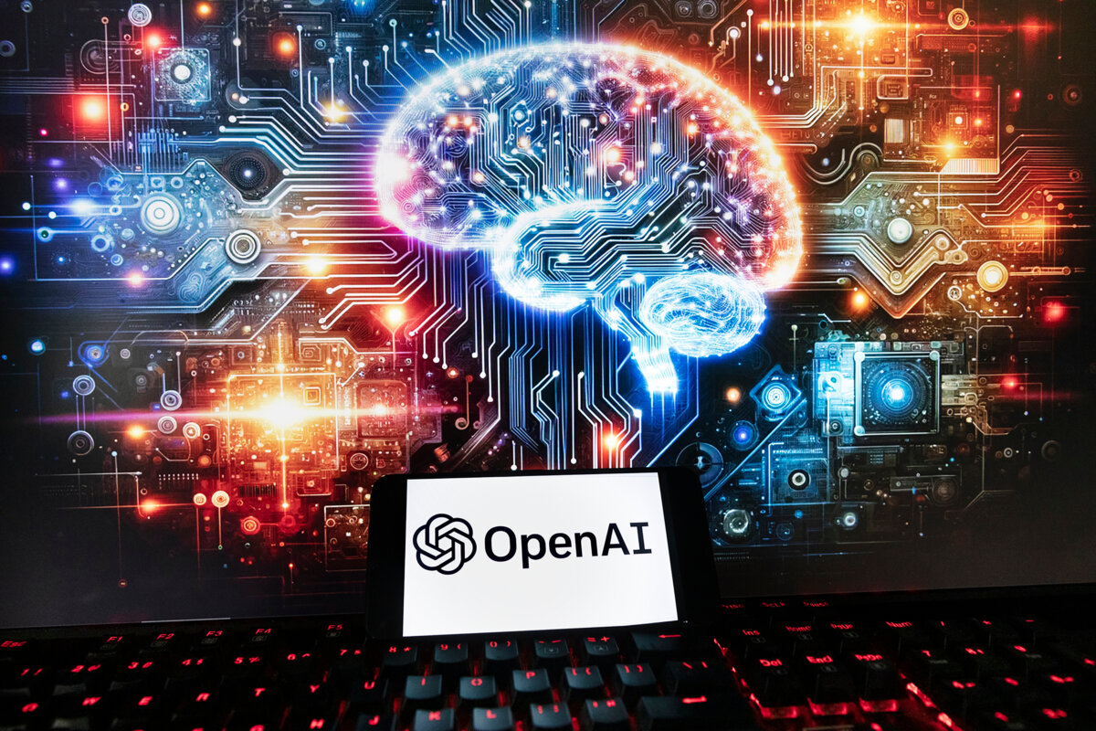 The OpenAI logo is displayed on a cellphone with an image on a computer monitor generated by ChatGPT's Dall-E text-to-image model, in Boston on Dec. 8, 2023. (AP Photo/Michael Dwyer, File)