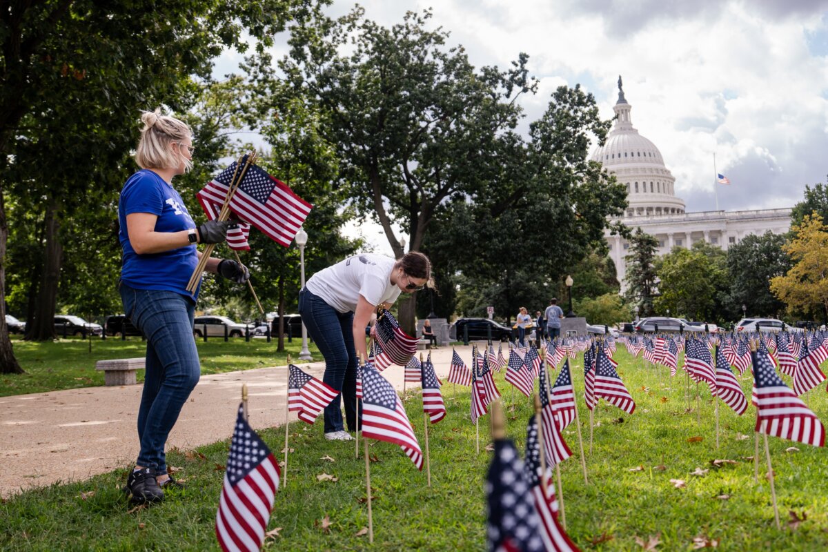 People place American flags on Capitol Hill in Washington on Sept. 11, 2025.(Madalina Kilroy/The Epoch Times)