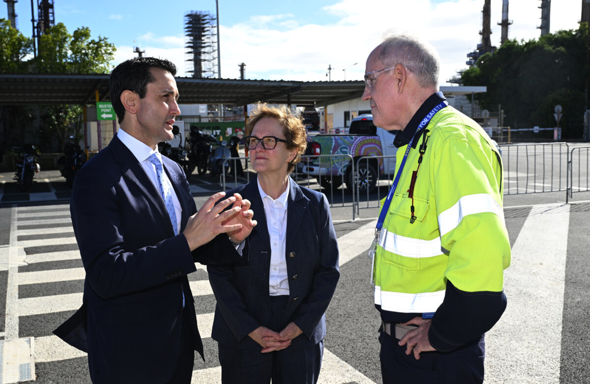 The Premier of Queensland, David Crisafulli (left) speaks with Michele Bardy (centre) executive general manager Infrastructure and Stuart Symons (right) Lytton refinery Manager at the Ampol Lytton Refinery in Brisbane, on April 22, 2026. (AAP Image/Darren England)