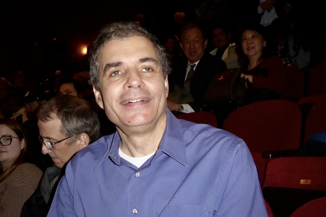 Chuck Cababe watches Shen Yun Performing Arts at the State Theatre New Jersey, in New Brunswick, N.J., on April 25, 2026. (Frank Liang/The Epoch Times)