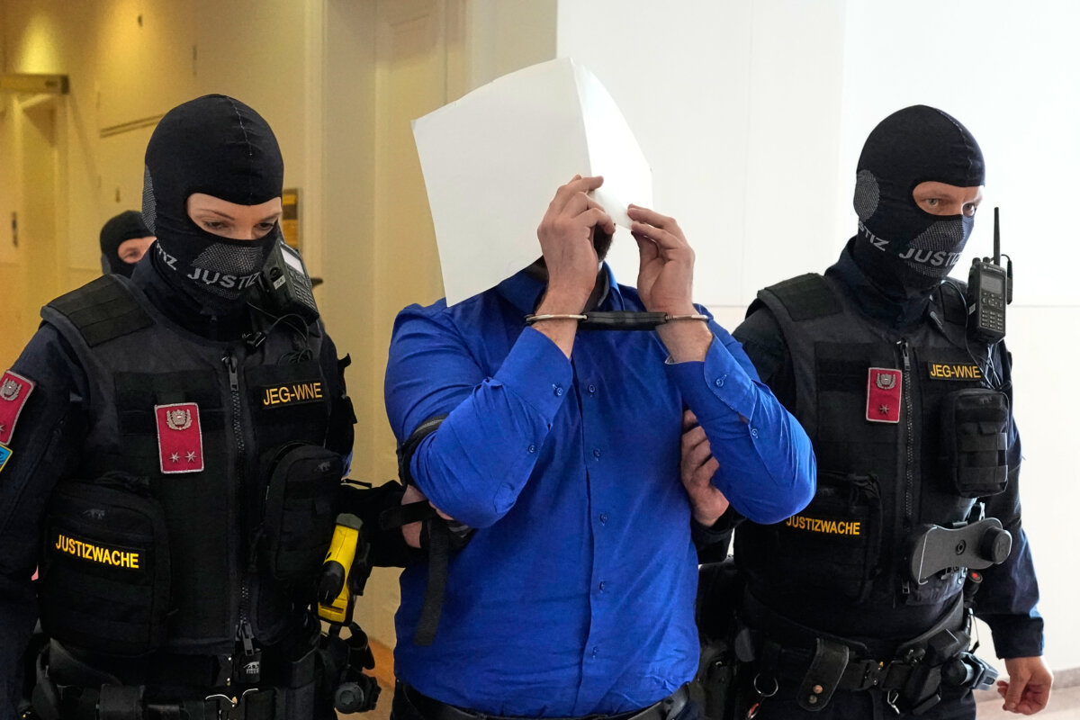 Defendant Beran A hides his face as he is escorted from the courtroom in Wiener Neustadt, Austria, on April 28, 2026, as he faces charges for plotting an attack on one of singer Taylor Swift's concerts in Vienna in August 2024 and pledging allegiance to the ISIS terrorist group. (Matthias Schrader/AP Photo)