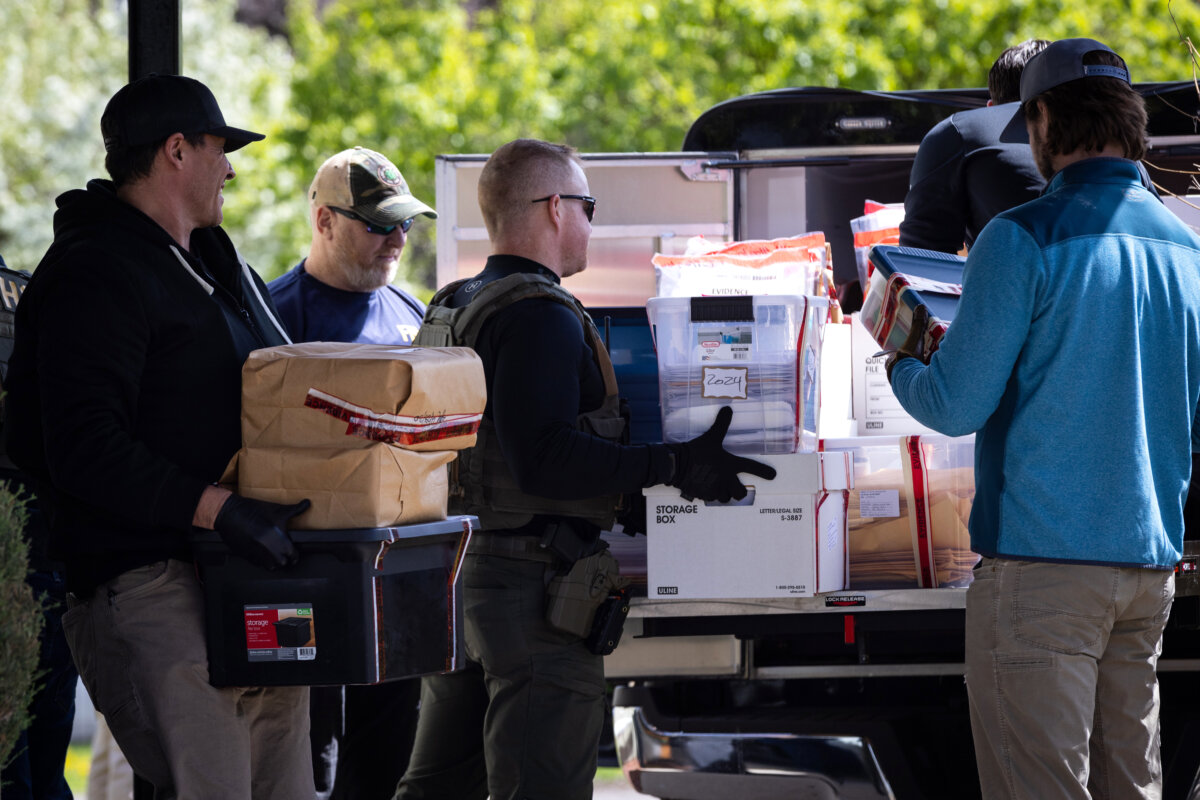 Federal and state officials load evidence into a vehicle as they execute a search warrant at The Original Childcare Center in south Minneapolis on April 28, 2026. (Ben Hovland/Minnesota Public Radio via AP)