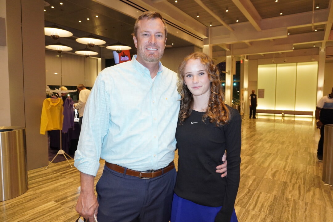 Justin Sherrod and his daughter attend the Shen Yun Performing Arts performance at Dr. Phillips Center for the Performing Arts on April 28, 2026. (Nancy Ma/The Epoch Times)
