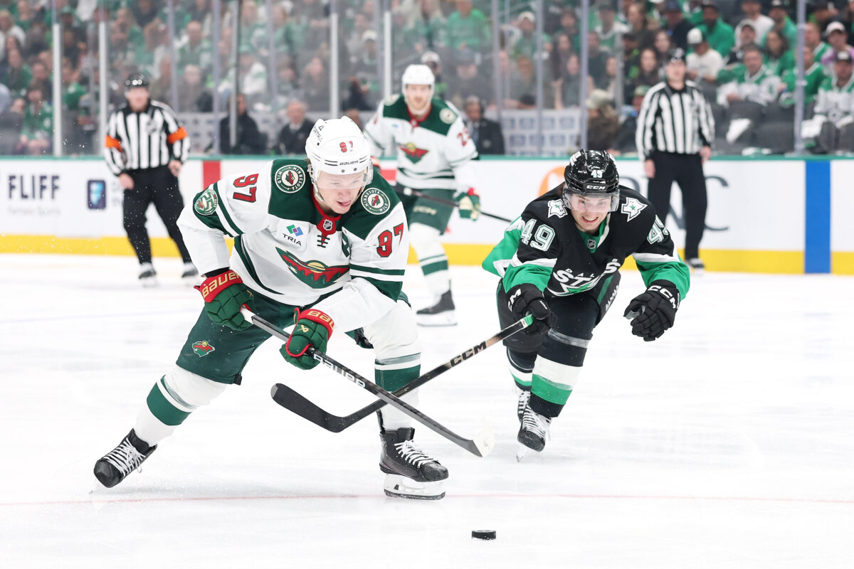 Kirill Kaprizov (#97) of the Minnesota Wild advances the puck under pressure from Justin Hryckowian (#49) of the Dallas Stars at the American Airlines Center in Dallas on April 28, 2026. (Stacy Revere/Getty Images)