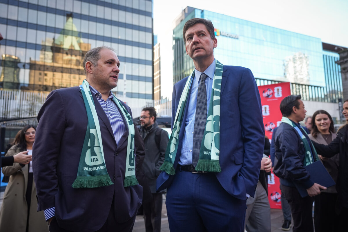 FIFA vice president and CONCACAF president Victor Montagliani (L) and B.C. Premier David Eby talk during the launch of the FIFA World Cup trophy tour, in Vancouver, on April 10, 2026. (The Canadian Press/Darryl Dyck)