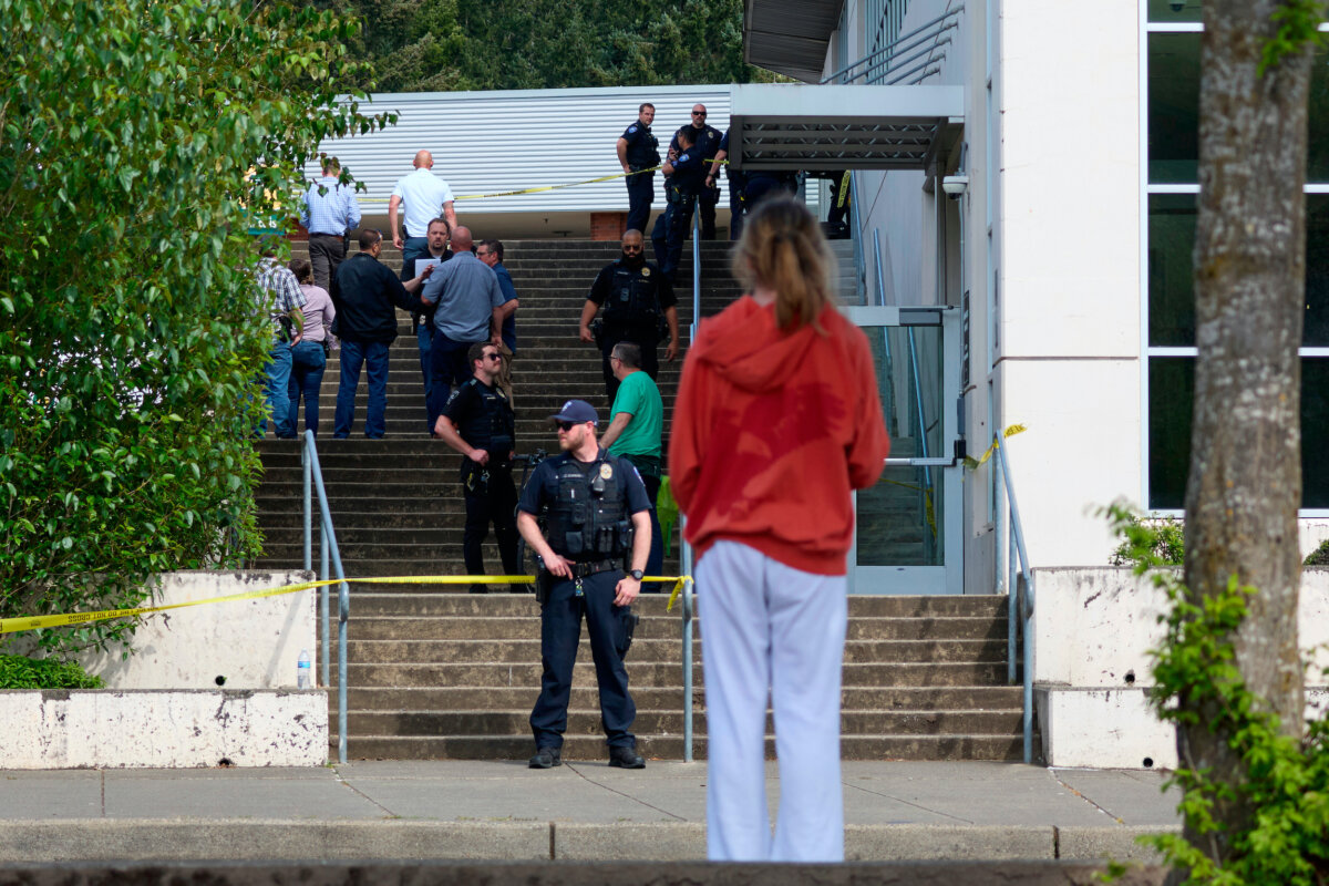 A student watches as Tacoma Police officers investigate after multiple people were injured in a stabbing at Foss High School in Tacoma, Wash., on April 30, 2026. (John Froschauer/AP Photo)