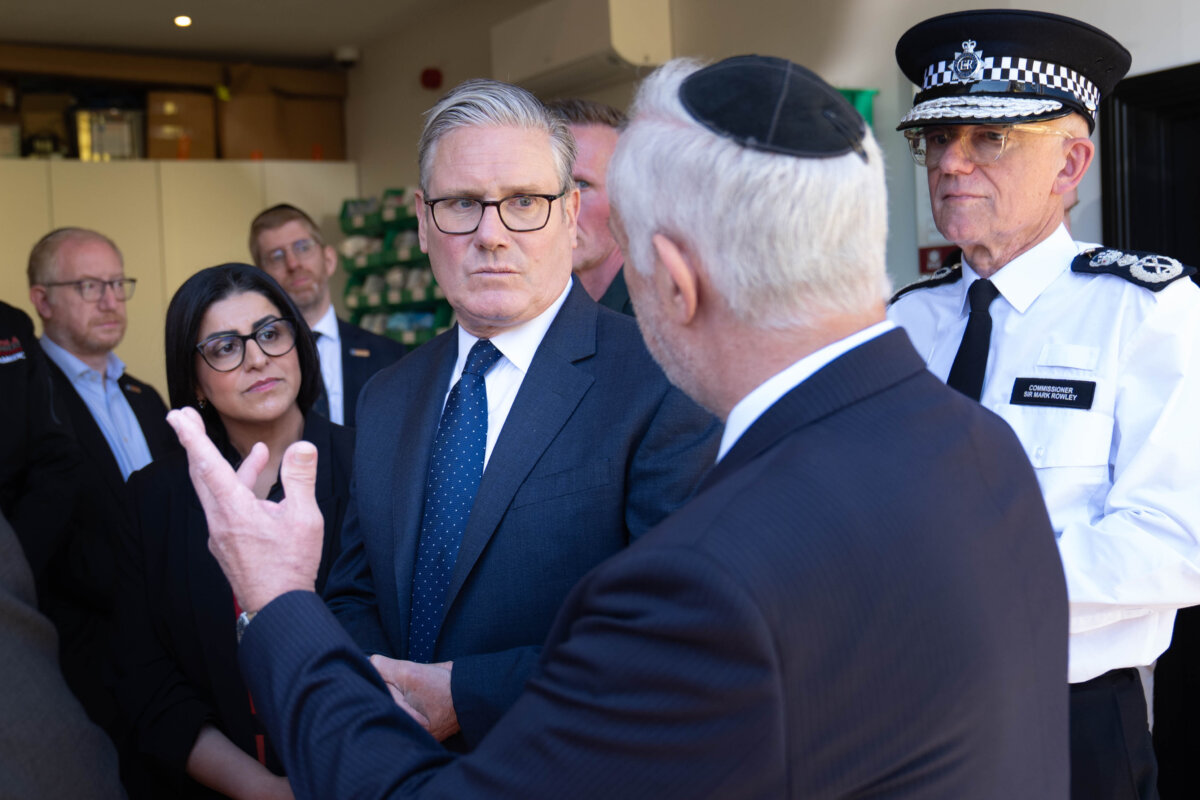 Britain's Prime Minister Keir Starmer (C), Metropolitan Police Commissioner Mark Rowley (R), and Home Secretary Shabana Mahmood (2nd L), speak with members of the Jewish community during a visit to Golders Green, north west London, on April 30, 2026, following an attack on Wednesday in which two men were stabbed. (Stefan Rousseau/Pool via AP)
