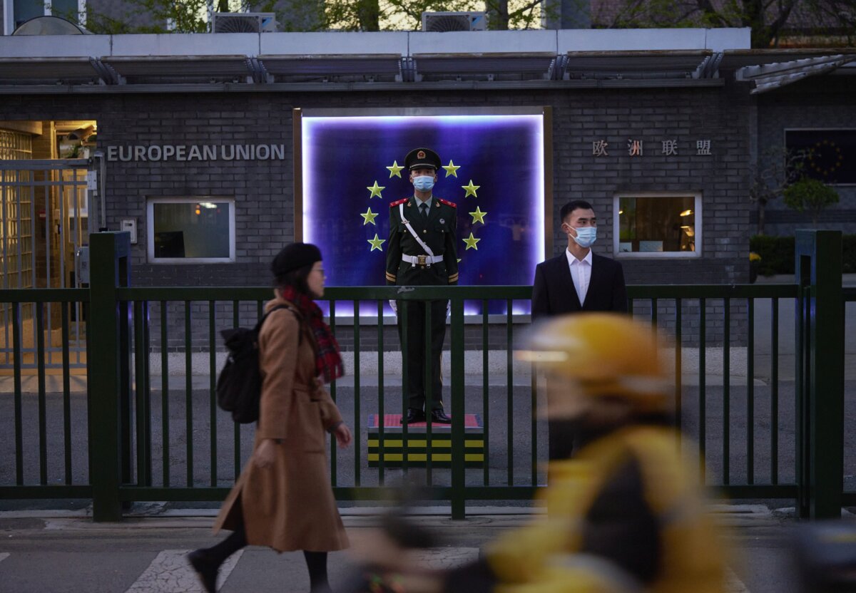 Members of the Peoples Armed Police stand guard in front of the flag of the European Union at the European Delegation before a press conference by European Commission President Ursula von der Leyen on April 6, 2023 in Beijing, China. (Kevin Frayer/Getty Images)