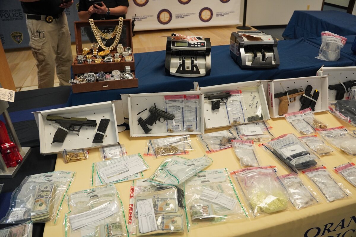 Seized jewelry, illegal firearms, cash, and narcotics on display at a news conference in Goshen, N.Y., on May 1, 2026. (Oliver Mantyk/The Epoch Times)