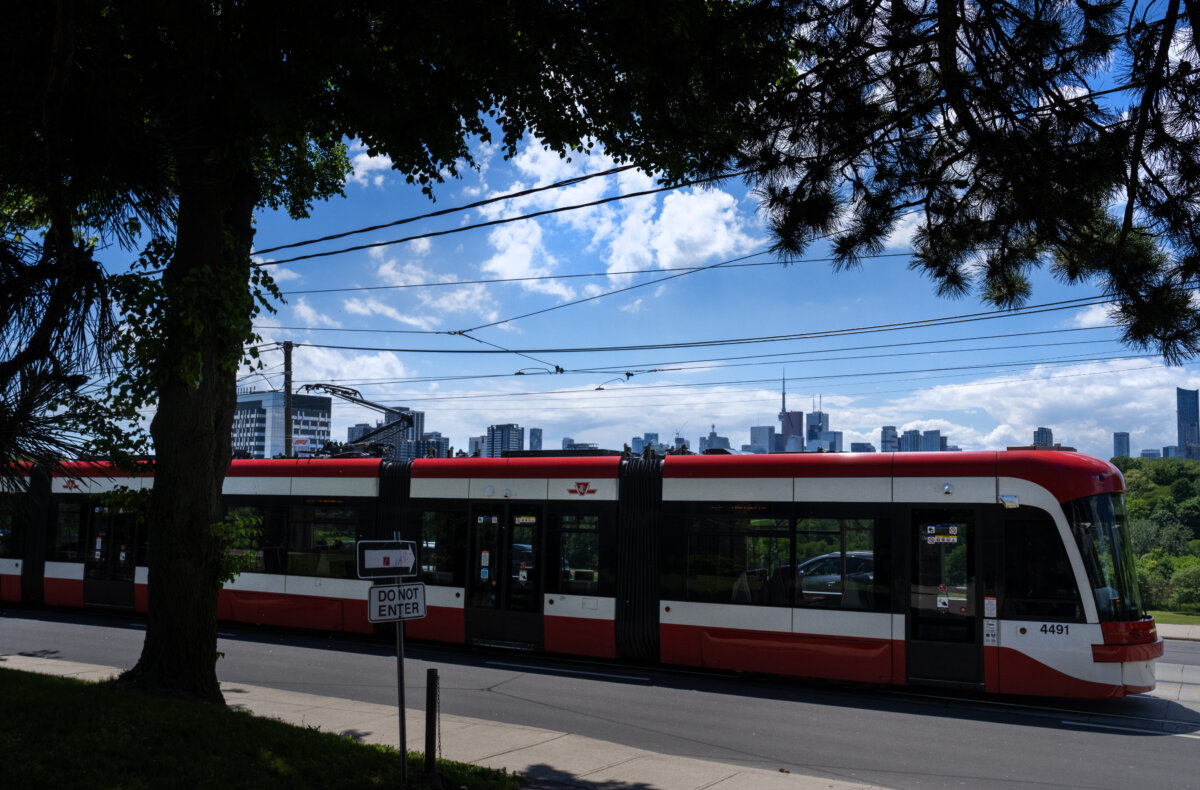 A Toronto Transit Commission streetcar drives past the downtown skyline in Toronto on June 6, 2024. (The Canadian Press/Frank Gunn)