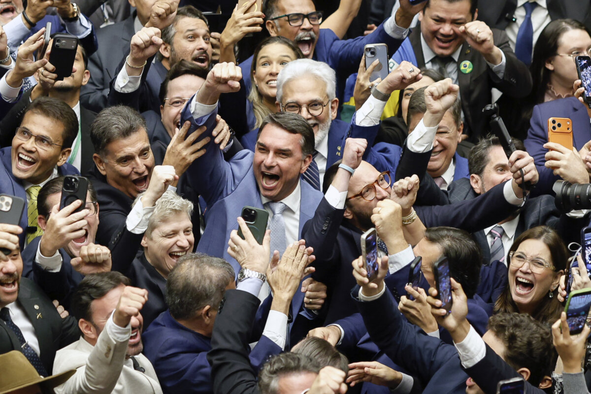 Sen. Flavio Bolsonaro (C) and others celebrate during a National Congress session that overturned President Luis Inácio Lula da Silva's veto of a bill reducing sentences for those convicted of attempted coup d’etat, in Brasilia on April 30, 2026. (Sergio Lima/AFP via Getty Images)
