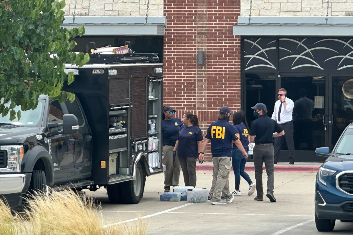 Law enforcement responds to the scene of a shooting at K Towne Plaza in Carrollton, Texas, on May 5, 2026. (Kendria LaFleur/AP Photo)