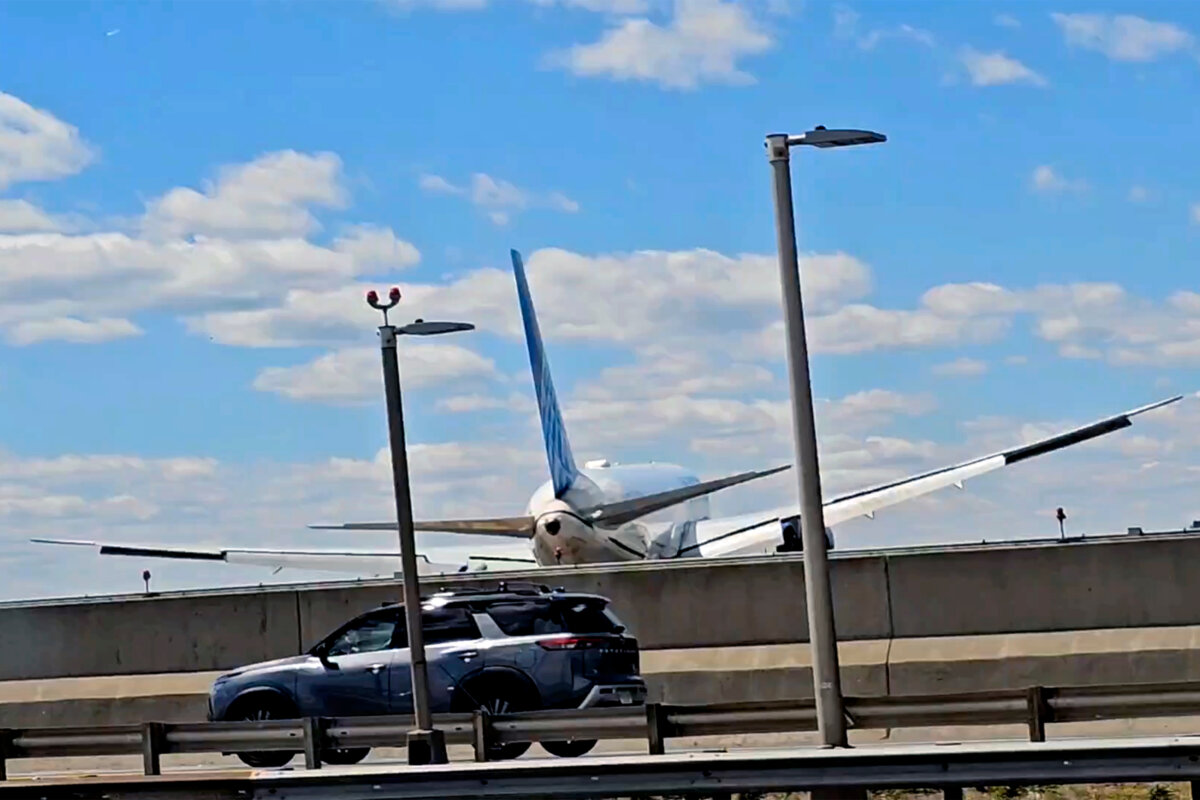 A United Airlines plane is seen in a still image taken from video after hitting a semitrailer truck and a light pole on the New Jersey Turnpike as it lands at Newark Liberty International Airport, on May 3, 2026. (Patrick Oyulu, via AP)