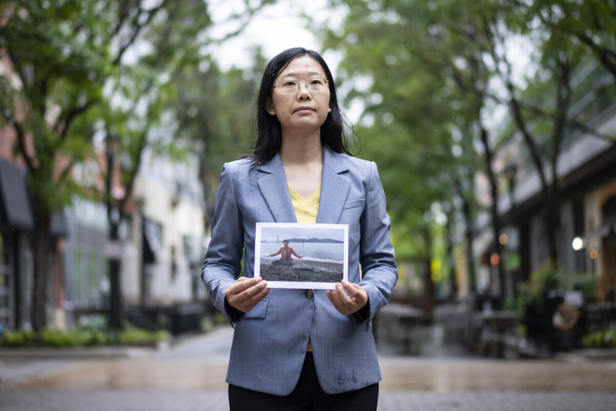 Alisa Zhou holds a photo of her mother, Wang Youmei who is being persecuted in China for practicing Falun Gong, in Rockville, Md., on May 6, 2026. (Madalina Kilroy/The Epoch Times)