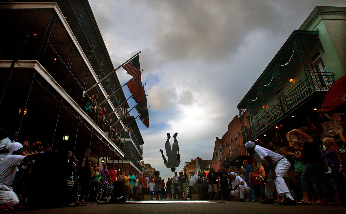 A street performer flips for the crowd on Bourbon Street in the French Quarter May 15, 2009, in New Orleans, Louisiana. (Mario Tama/Getty Images/TNS)