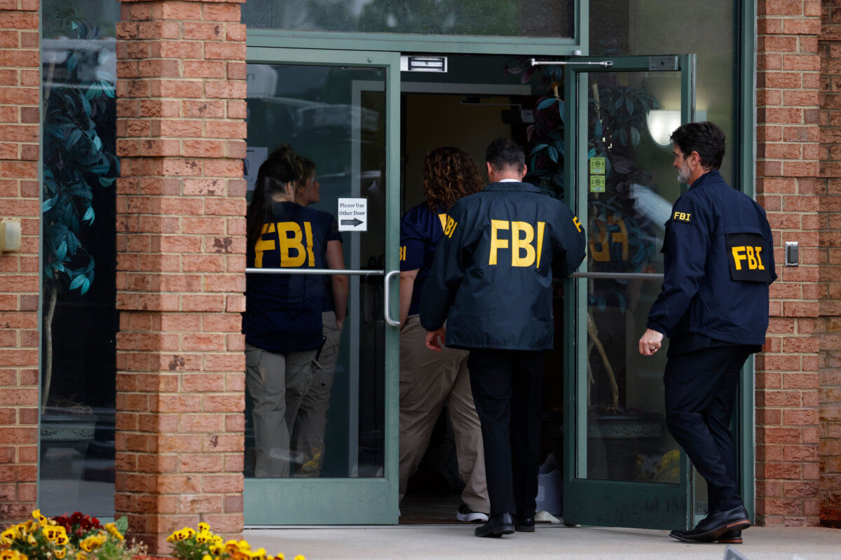 FBI personnel enter a building in Portsmouth, Va., on May 6, 2026. (Peter Casey/The Virginian-Pilot via AP)