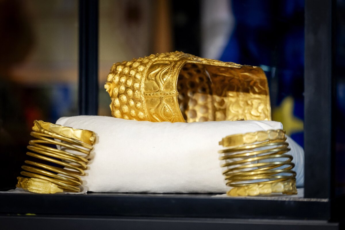 The recovered golden helmet of Cotofenesti and two gold bracelets that were stolen from the Drents Museum are displayed in a glass box in Assen, Netherlands on April 2, 2026. (Sem van der Wal / Getty Images)