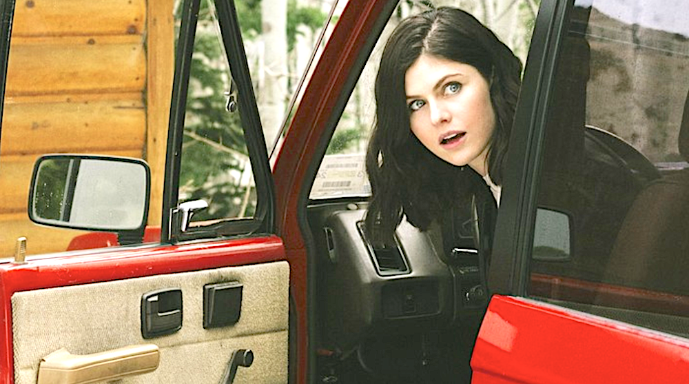dark haired woman in bright red car in Couples Weekend