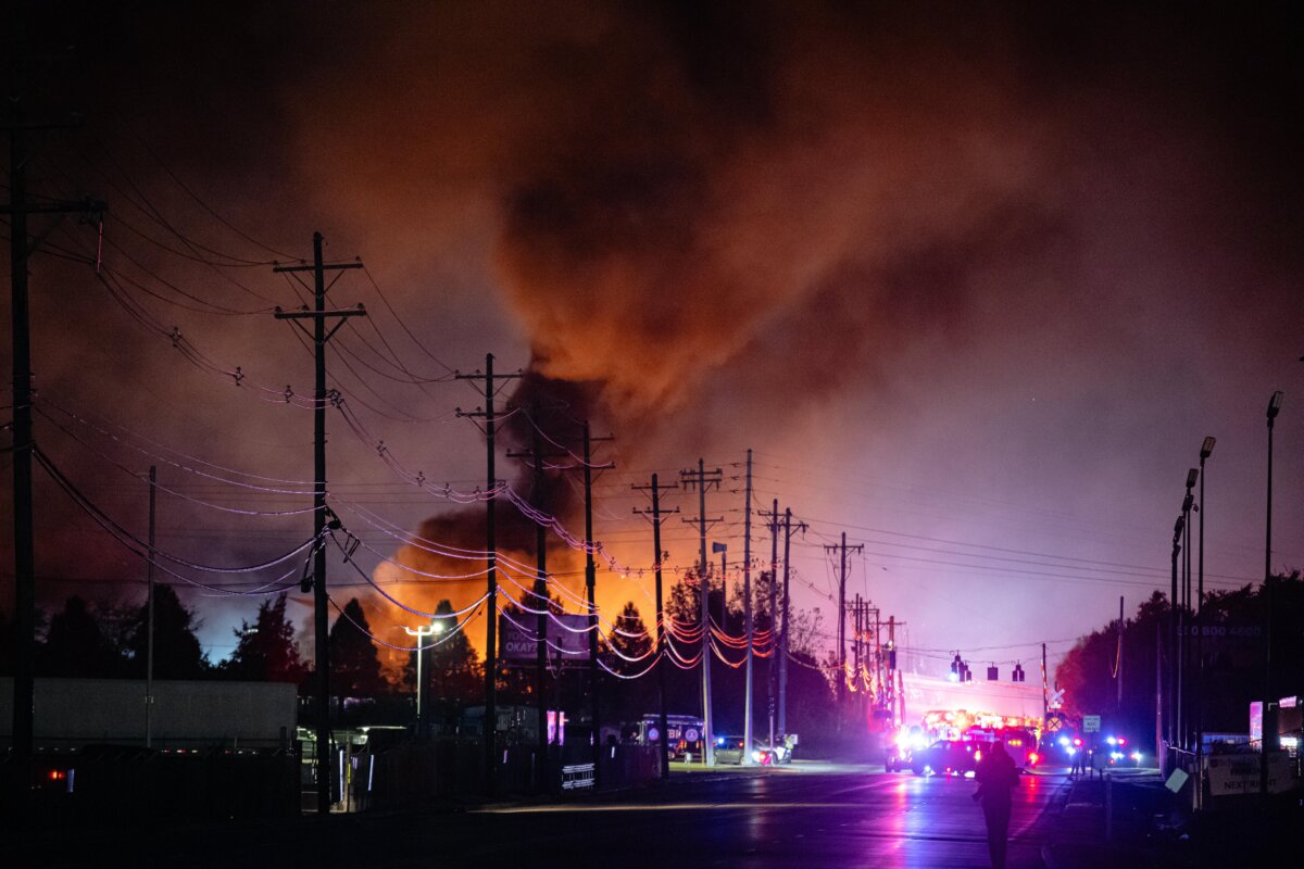 Plumes of smoke rise from the area of a UPS cargo plane crash at Louisville Muhammad Ali International Airport, Nov. 4, 2025, in Louisville, Ky. (Jon Cherry/AP Photo)