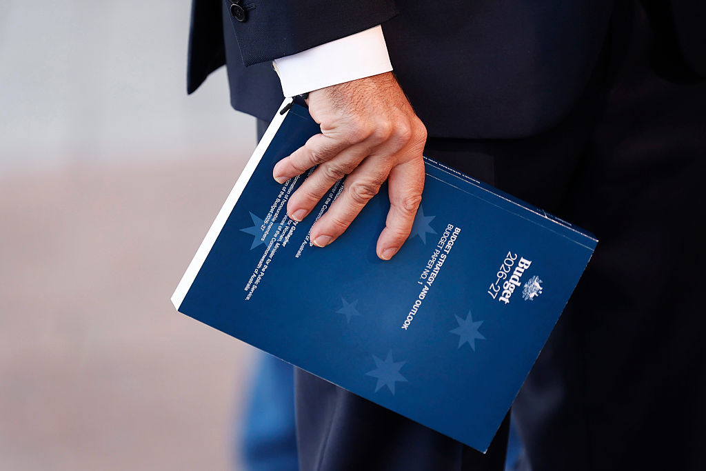 Treasurer Jim Chalmers holds a copy of the 2026 budget while speaking with the media at Australian Parliament House in Canberra, Australia, on May 12, 2026. (Hilary Wardhaugh/Getty Images)