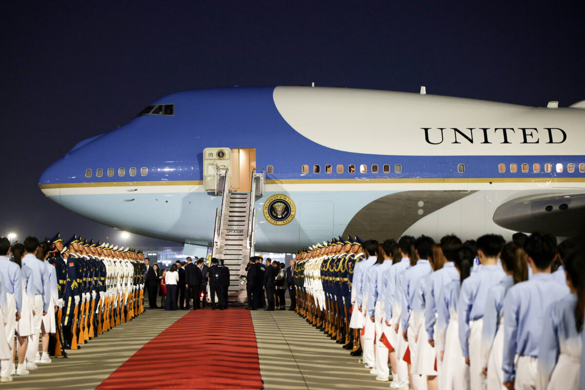 Chinese officials greet U.S. President Donald Trump as he arrives on Air Force One at Beijing Capital International Airport in Beijing on May 13, 2026. (Alex Wong/Getty Images)