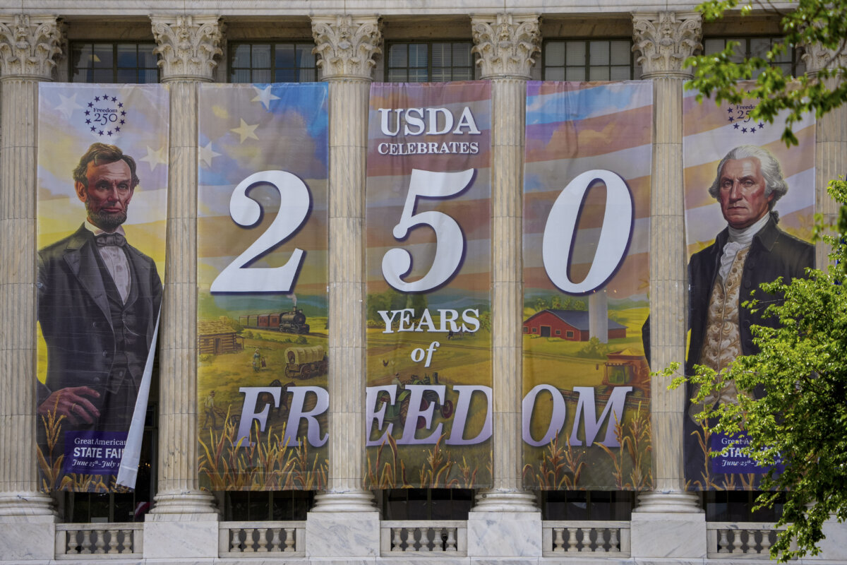 Banners hang from the Department of Agriculture as workers continue to build out Freedom 250's Great American State Fair infrastructure on the National Mall in Washington on May 14, 2026. (Andrew Harnik/Getty Images)