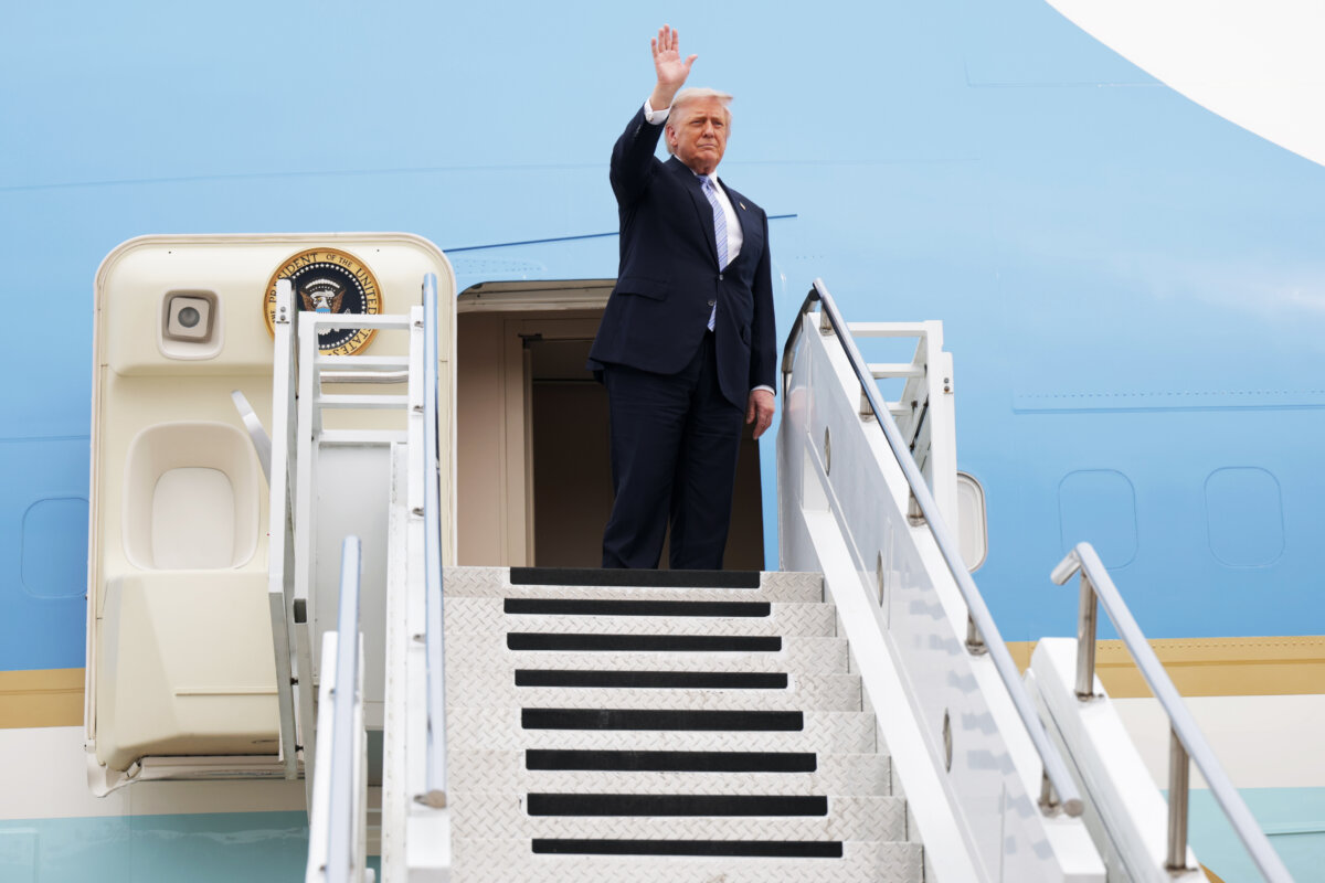 U.S. President Donald Trump waves as he prepares to board Air Force One at Beijing Capital International Airport in Beijing on May 15, 2026. (Alex Wong/Getty Images)