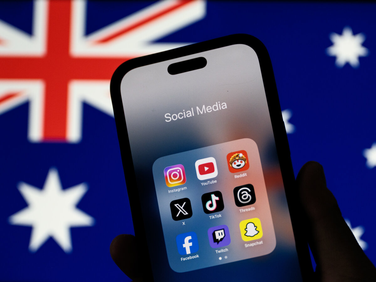 In this photo illustration, social media networking apps are displayed on a phone screen with the Australian flag displayed in the background in Sydney, Australia on Dec. 7, 2025. (George Chan/Getty Images)