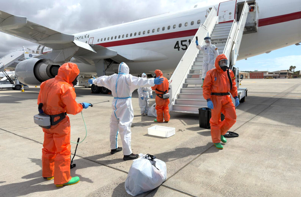A Spanish passenger is sprayed with disinfectant by Spanish government officials before boarding a plane after disembarking from the hantavirus-stricken cruise ship MV Hondius at Tenerife airport in the Canary Islands, Spain, on May 10, 2026. (AP Photo)