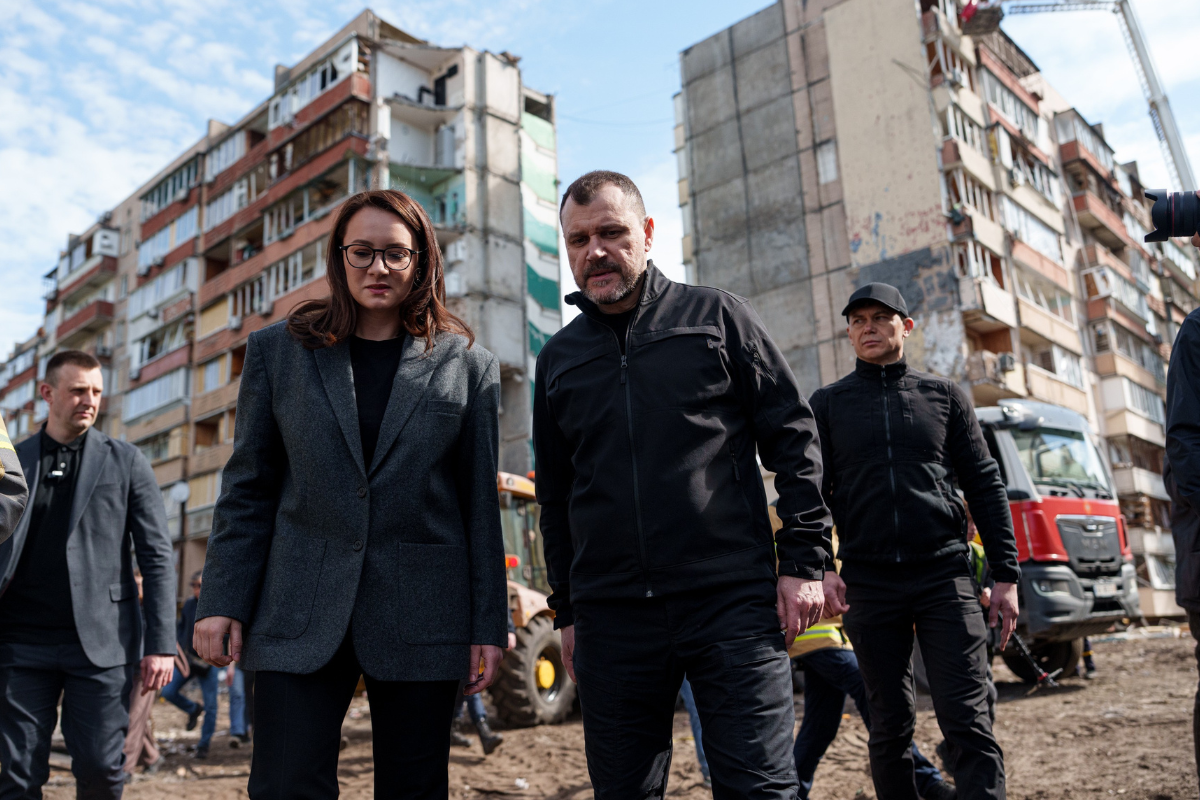 Ukrainian Prime Minister Yulia Svyrydenko (L) and Ukrainian Interior Minister Ihor Klymenko (R) walk in the yard of an apartment building heavily damaged after a Russian strike on a residential neighborhood in Kyiv, Ukraine, on May 15, 2026. (Evgeniy Maloletka/AP Photo)