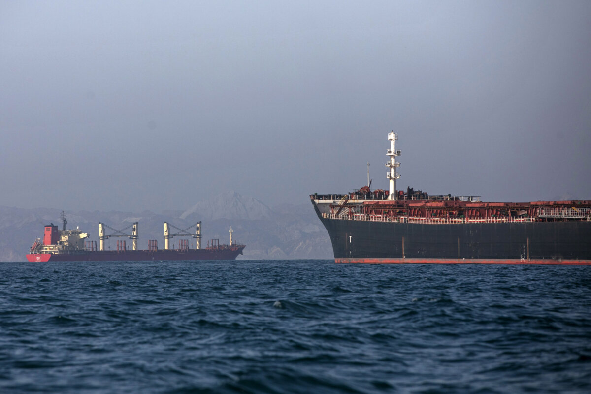 An Iranian tugboat is in the foreground as cargo ships sit at anchor in the Strait of Hormuz off Bandar Abbas, Iran, on May 4, 2026. (Amirhosein Khorgooi/ISNA via AP)